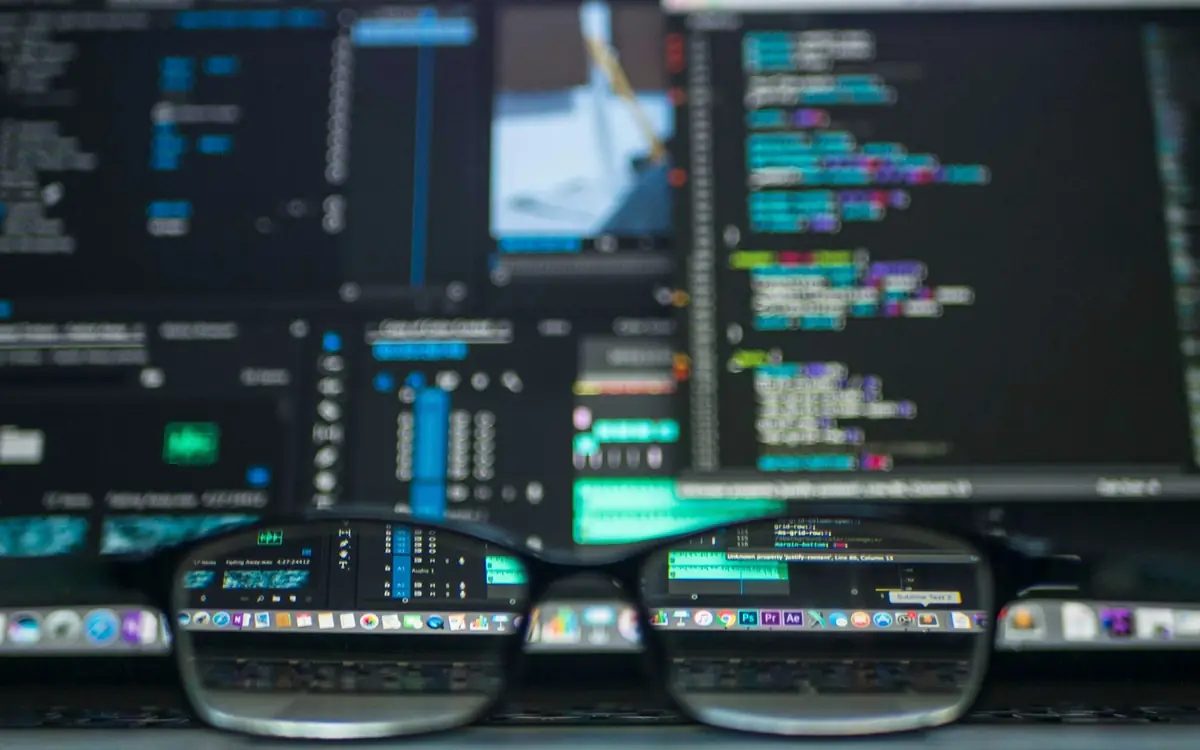 Developer workstation with application source code on multiple screens